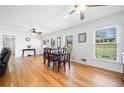 Bright living room with hardwood floors, classic furnishings, and natural light streaming through large windows with mini blinds at 630 Cambridge Dr, Marietta, GA 30066
