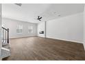 Bright, open living room featuring stylish wood-look floors, neutral walls, and a modern ceiling fan, offering a versatile space at 342 Overlook Rd, Covington, GA 30014