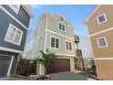 Three-story home with a two-car garage, trimmed windows, and private elevated deck at 735 Ponce De Leon Pl Ne Unit 1, Atlanta, GA 30306