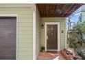 Home's front door is adorned with plants, a brick walkway, and a small covered porch at 735 Ponce De Leon Pl Ne Unit 1, Atlanta, GA 30306