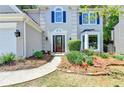 Lovely home with a well-kept lawn and colorful flower beds leading to a charming front entrance at 335 Wyehwood Ct, Alpharetta, GA 30022