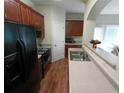 Kitchen with dark cabinets, stainless steel sink, and black appliances at 2162 Oakland Grove Pl, Lawrenceville, GA 30044