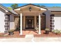 Inviting front porch with stone columns and a beautifully detailed front door at 2320 Copper Trail Ln, Buford, GA 30519