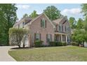 Brick exterior home with a manicured lawn and a curved driveway leading to the side-entry garage at 553 Augusta Dr, Canton, GA 30115