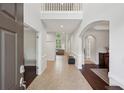 Grand foyer with soaring ceilings, decorative wainscoting, and a view through to the formal living area at 553 Augusta Dr, Canton, GA 30115