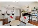 Open-concept living area with a piano, and a stylish kitchen, complemented by modern furnishings and hardwood floors at 1080 Peachtree Ne St # 3213, Atlanta, GA 30309