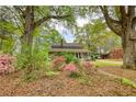 Charming brick home featuring a welcoming front porch, beautiful landscaping, and an inviting facade at 177 Fairview Dr, Fairburn, GA 30213