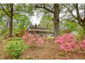 Charming brick home featuring a welcoming front porch, beautiful landscaping, and an inviting facade at 177 Fairview Dr, Fairburn, GA 30213