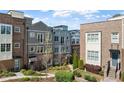 Exterior shot of townhomes, complemented by lush landscaping and walking paths at 6135 Redwine St, Norcross, GA 30071