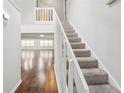 Inviting staircase with wood floors and white banister leading to the upper level at 2988 Chipmunk Se Trl, Marietta, GA 30067