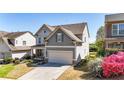 Two-story home with gray vinyl siding, landscaped yard, and attached two-car garage at 625 Lorimore Pass, Canton, GA 30115