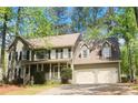 Inviting two-story home with a covered front porch, dormer windows, and an attached two-car garage at 863 Fairwood Pointe Nw, Acworth, GA 30101