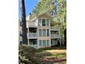 Rear exterior view of a two-story home featuring multiple balconies and lush greenery at 1504 Augusta Se Dr, Marietta, GA 30067
