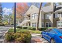 Two-story condo with balcony, framed by mature trees and meticulous landscaping at 208 Bainbridge Dr, Atlanta, GA 30327