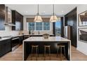Modern kitchen with black cabinets, stainless steel appliances, and a large center island with barstool seating at 946 Hughley Circle # 98, Atlanta, GA 30316