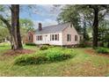 A charming home showcasing a well-manicured lawn and mature trees against a blue sky at , Tucker, GA 30084