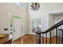 Bright foyer featuring hardwood floors, double entry doors, and staircase with wrought iron railing at 1151 Goodwin Ne Rd, Brookhaven, GA 30324