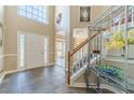 Bright foyer with tiled floors, a decorative glass door, and a staircase at 1356 Belfaire Trce, Dacula, GA 30019