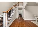 Spacious foyer features hardwood floors and staircase with wood railing at 1420 Lockridge Dr, Cumming, GA 30041