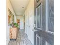 Inviting entryway with wood-look floors, modern decor, and a view into the bright, open-concept living space at 2142 Theberton Trl, Locust Grove, GA 30248