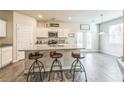 Bright kitchen with granite countertops, stainless steel appliances, and barstool seating at the island at 2142 Theberton Trl, Locust Grove, GA 30248