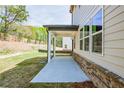 Covered back porch with brick foundation and white support posts, offering a relaxing outdoor space at 4275 Montane St, Cumming, GA 30028