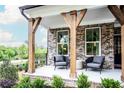 Inviting front porch with timber posts, outdoor seating, and manicured landscaping at 4725 Montane St, Cumming, GA 30028