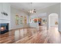 An open-concept living area showcases hardwood floors, a fireplace, and access to the kitchen at 660 Gran Heritage Way, Dacula, GA 30019