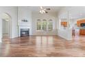A spacious living room features hardwood floors, fireplace, and large windows that provide natural light at 660 Gran Heritage Way, Dacula, GA 30019