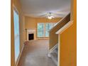 Open-concept living area featuring a fireplace and ample natural light at 445 Pintail Ct, Suwanee, GA 30024