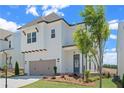 Charming two-story home with a gray two car garage and a landscaped front yard at 627 Skytop Dr, Cumming, GA 30040