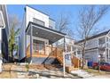 Modern two-story home with a covered front porch and wooden stairs at 906 Mcdaniel St, Atlanta, GA 30310