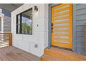 Modern front door with side window, porch, and modern exterior light fixture at 906 Mcdaniel St, Atlanta, GA 30310