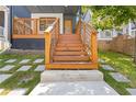The home's front entrance features a wooden staircase and modern concrete walkway at 906 Mcdaniel St, Atlanta, GA 30310