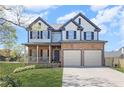 Beautiful two-story home featuring a classic design, stone accents, and an attached two-car garage at 2625 Cross Springs Dr, Cumming, GA 30041