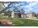 Landscaped home featuring a quaint front porch, well-manicured lawn, and a two-car garage, nestled within a verdant neighborhood at 2625 Cross Springs Dr, Cumming, GA 30041