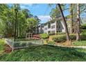 Exterior view of a two-story condo with lush landscaping and a gazebo at 305 Summit North Ne Dr # 305, Atlanta, GA 30324