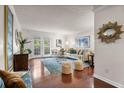 Bright living room with hardwood floors, stylish furnishings, and access to a balcony at 3701 Essex Ave # 2, Atlanta, GA 30339
