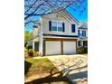 Beautiful two-story home featuring a brick-accented two-car garage and well-maintained landscaping at 5485 Mountain Top Pl, Cumming, GA 30041