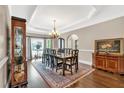 Formal dining room boasts a tray ceiling, chandelier, and space for large gatherings at 850 Highland Bend Cv, Alpharetta, GA 30022
