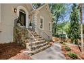 Inviting front entrance featuring stone steps, black railings, and a beautifully designed front door with an arch window at 1183 Woods Ne Cir, Atlanta, GA 30324