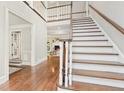 Elegant staircase showcasing wood treads, white risers, and views into a living room with a fireplace at 1183 Woods Ne Cir, Atlanta, GA 30324