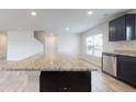 Kitchen island with granite countertop and dark wood cabinetry at 160 Weldon Rd, Mcdonough, GA 30253