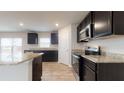 Kitchen features granite countertops, stainless steel appliances and dark wood cabinetry at 160 Weldon Rd, Mcdonough, GA 30253