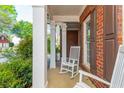 Relaxing front porch with brick columns and charming rocking chairs at 2810 Stillwater Park Dr, Marietta, GA 30066