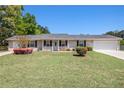 Attractive single-story home with a lush green lawn and a welcoming front entrance at 3998 Wabash Ln, Ellenwood, GA 30294