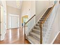 Elegant foyer with hardwood floors, chandelier, staircase, and decorative glass above the front door at 1740 Manhasset Pl, Atlanta, GA 30338