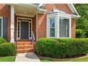 Close-up of the home's front entrance, featuring a stylish door and well-maintained landscaping at 1740 Manhasset Pl, Atlanta, GA 30338