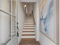 Welcoming entryway with a stairway featuring hardwood treads and an elegant art piece on the wall at 200 Pinecone Pl, Alpharetta, GA 30022