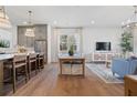 Open concept living space with kitchen, dining area, and living room with hardwood floors at 200 Pinecone Pl, Alpharetta, GA 30022